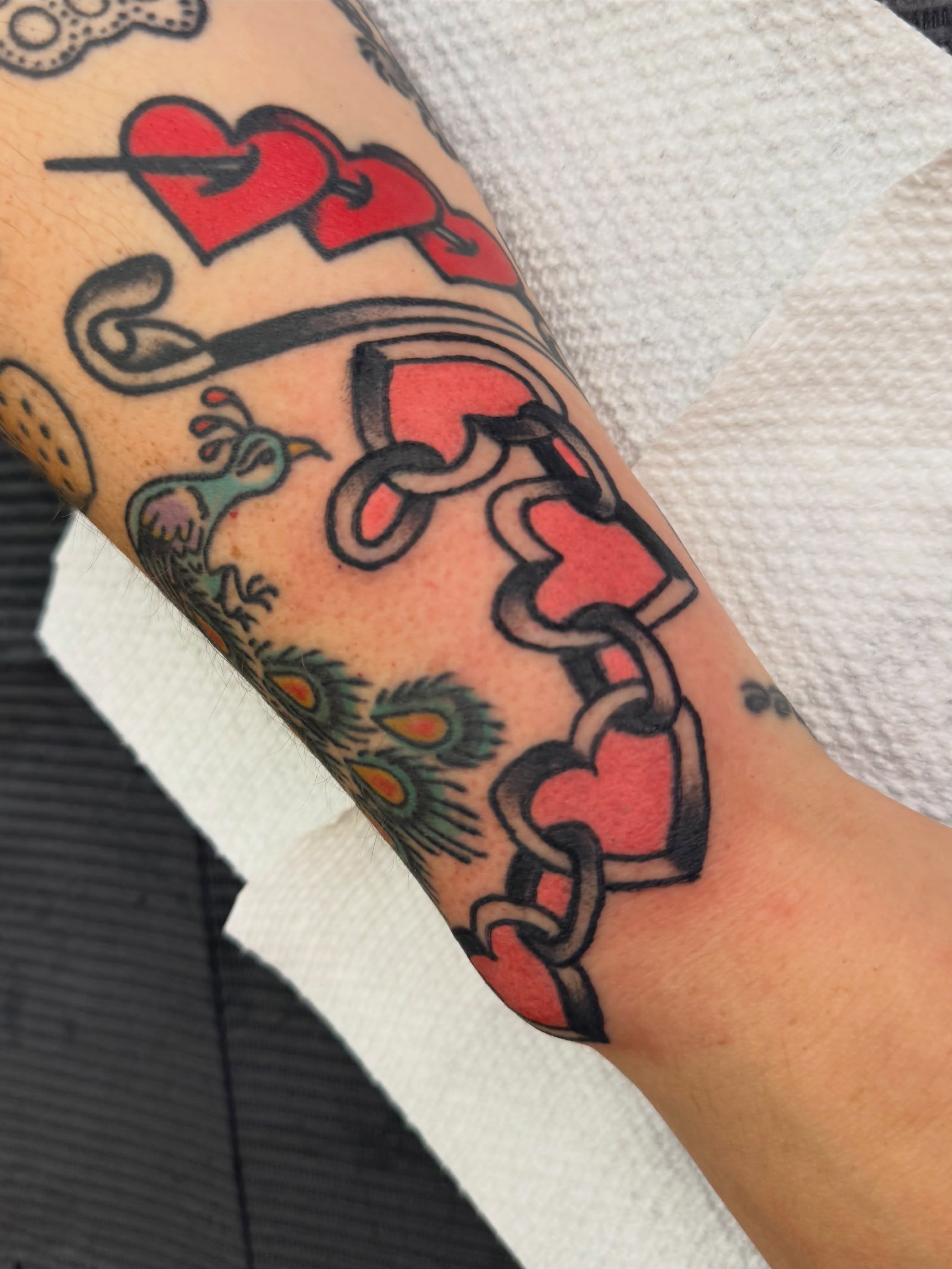 Chain and hearts American traditional tattoo on the forearm by 🪩 Marisa Rae Mathews 🪩, McKees Rocks, Pennsylvania