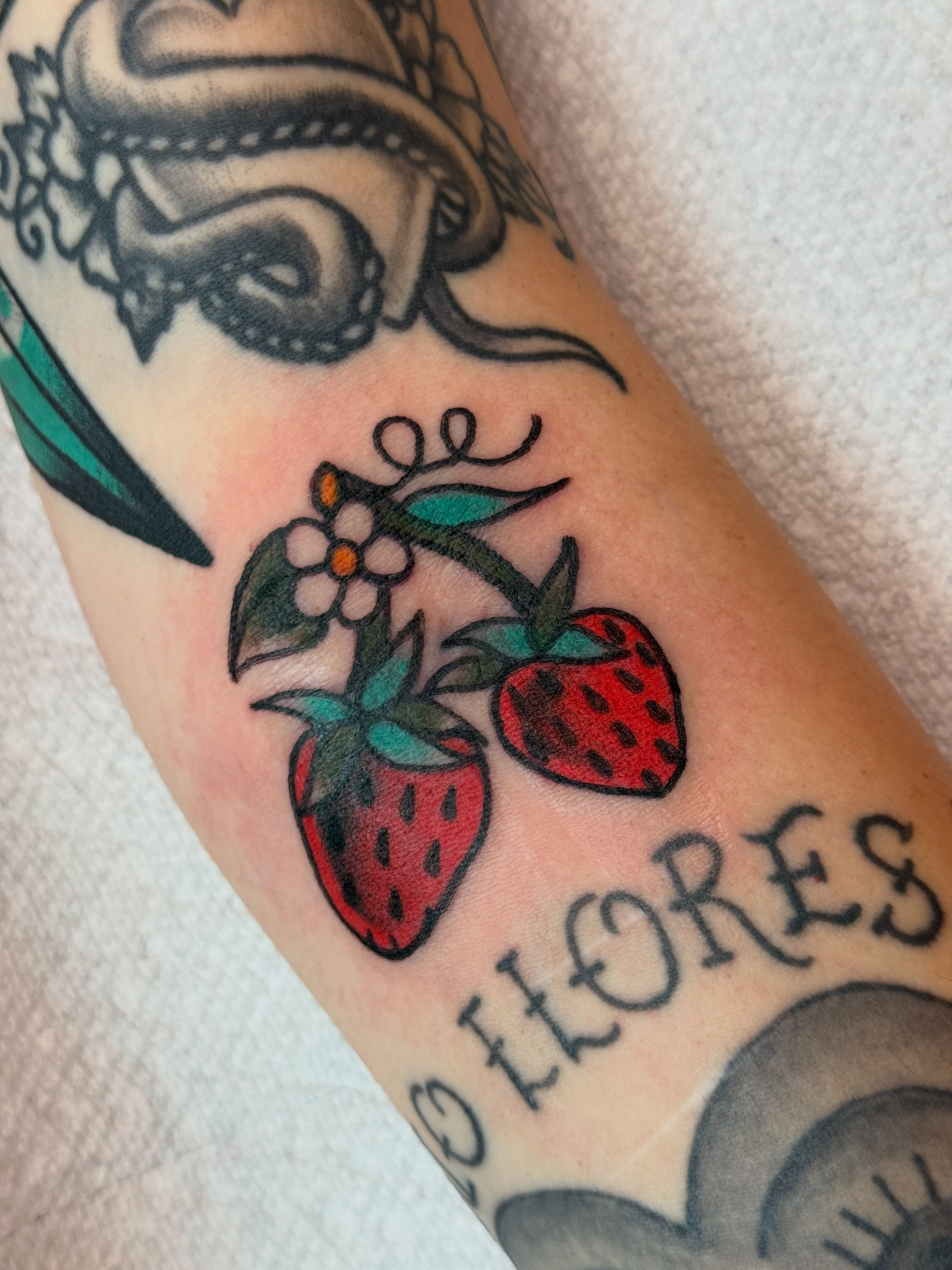Strawberries and flowers American traditional tattoo on the forearm by 🪩 Marisa Rae Mathews 🪩, McKees Rocks, Pennsylvania