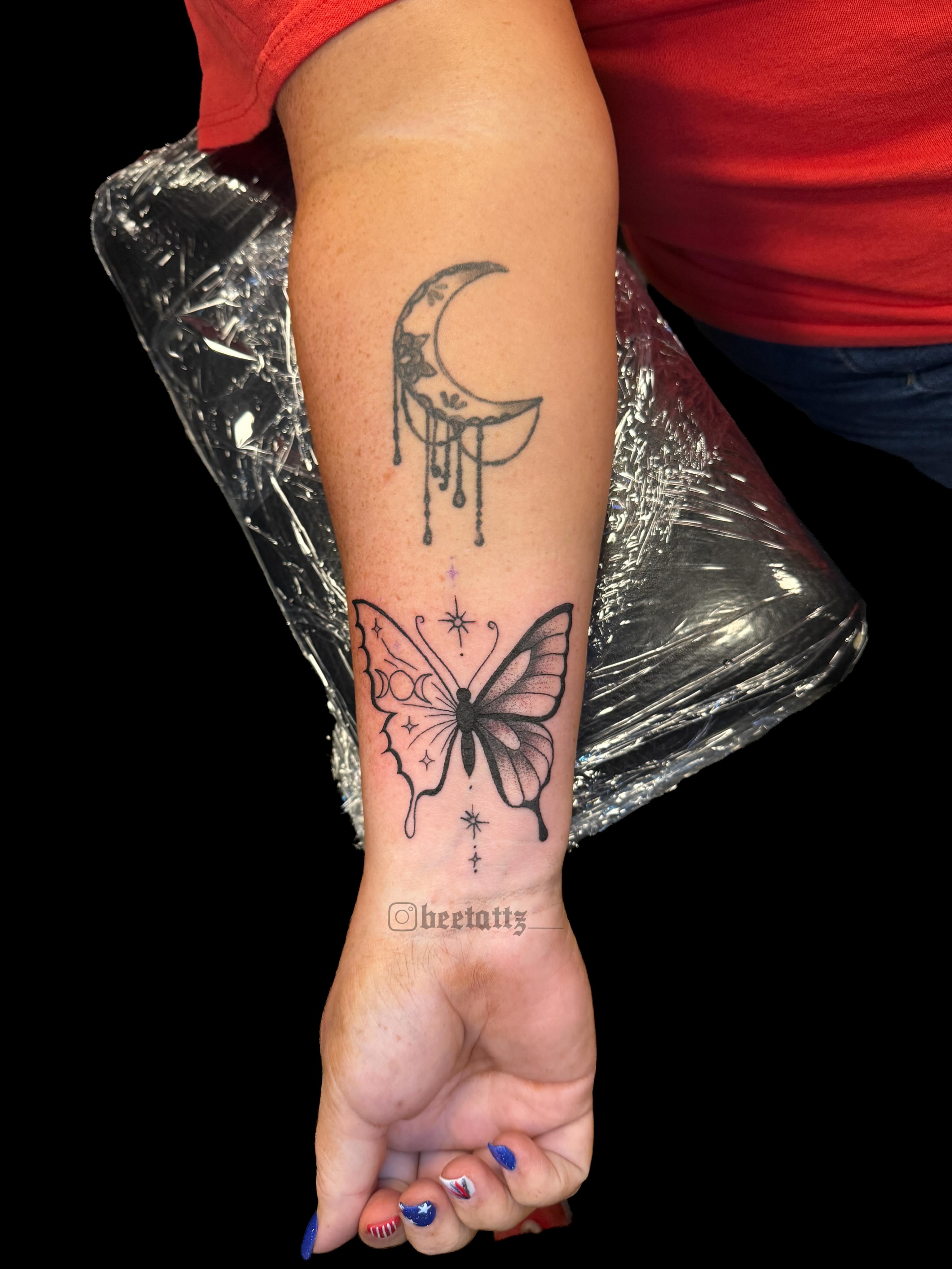 Butterfly and crescent moon dotwork tattoo on the forearm by Brinkley McGill