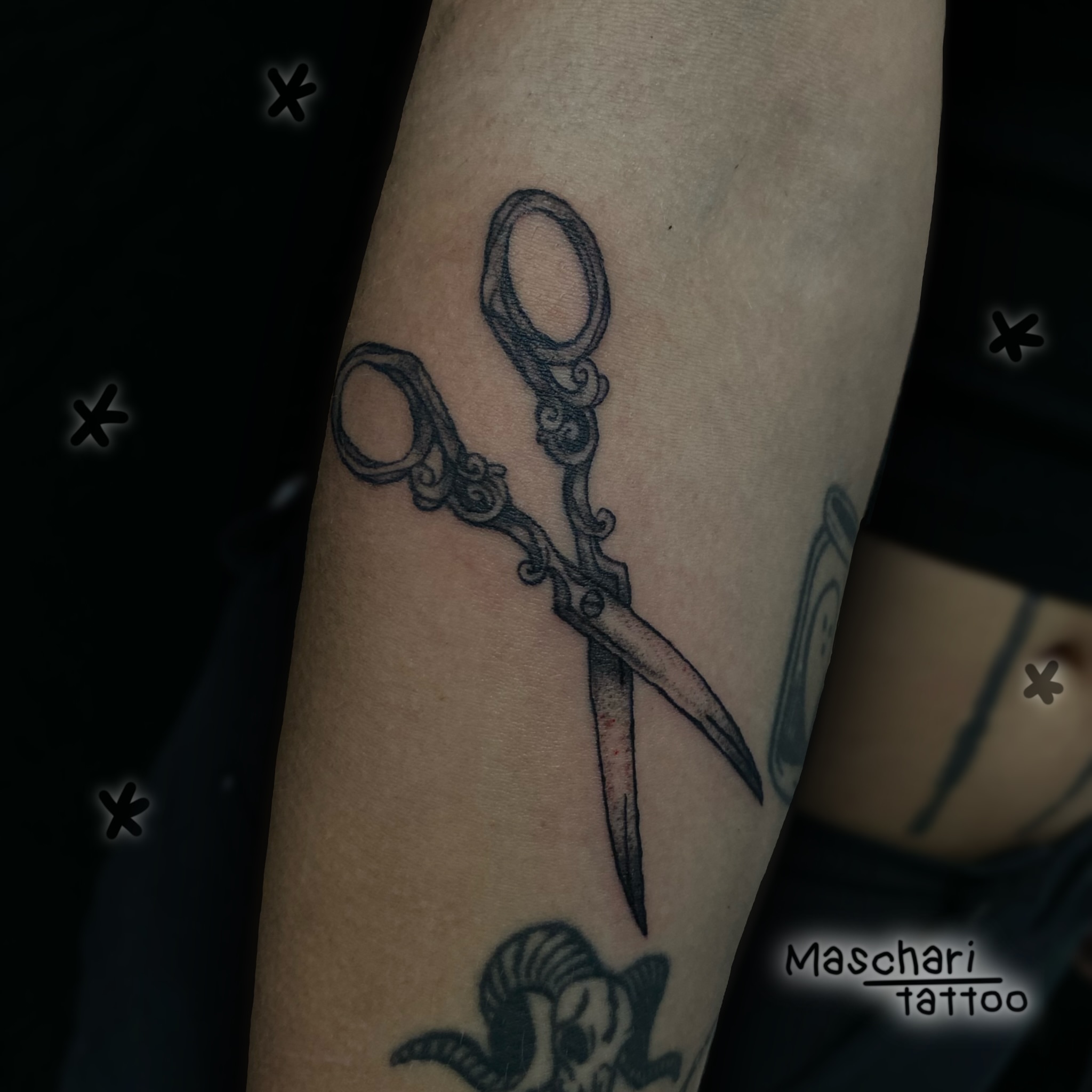 Ornate scissors minimalist tattoo on the forearm by ande