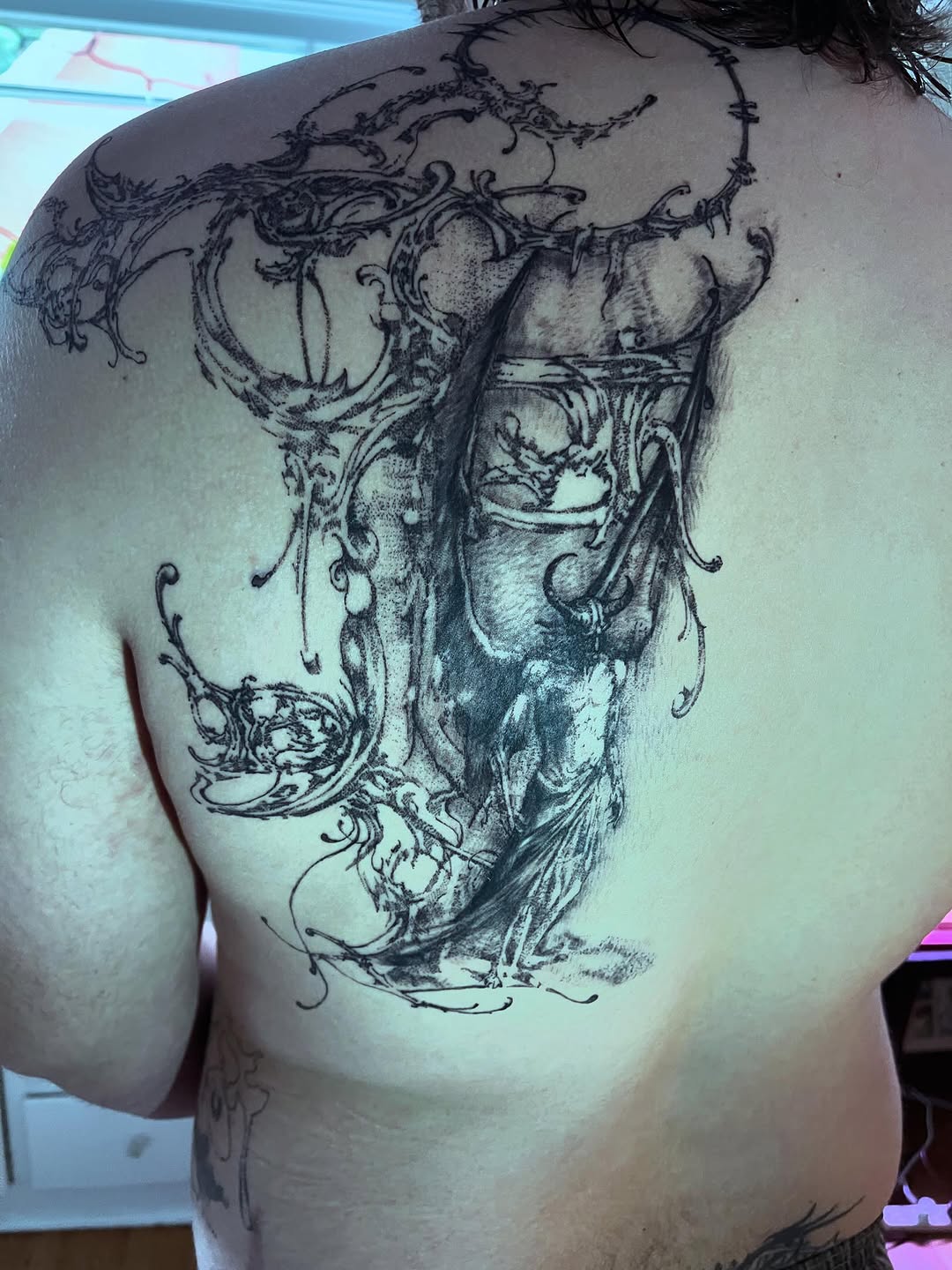 Ornate figure with swirling patterns sketch tattoo on the back by @initiationoftorture