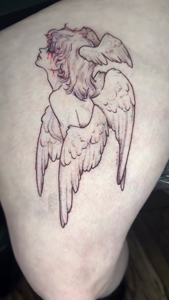 Cherub with wings realism tattoo on the thigh by Seattle Cybersigilism Tattoo Horror