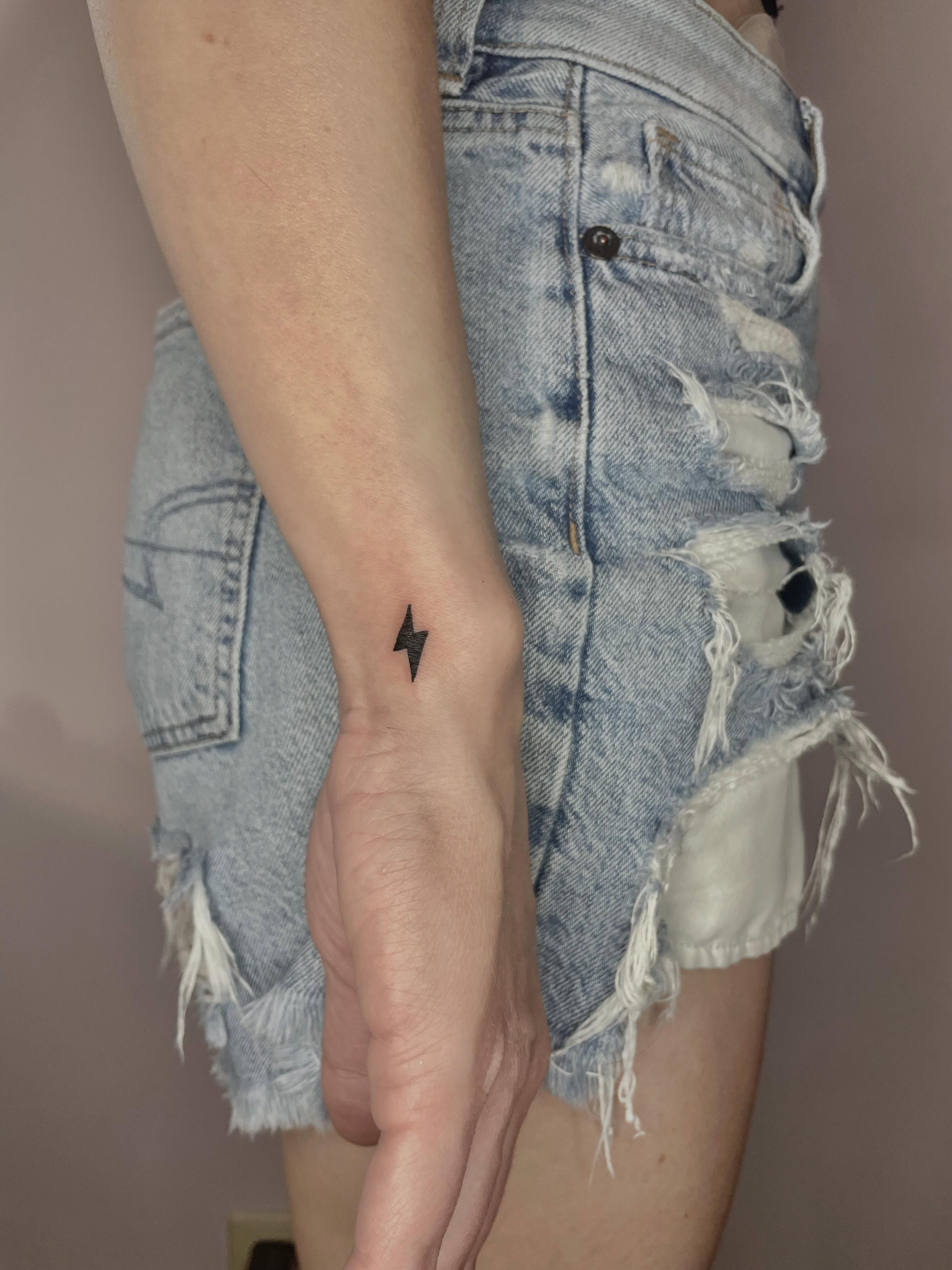 Lightning bolt geometric tattoo on the forearm by Sierra Seton