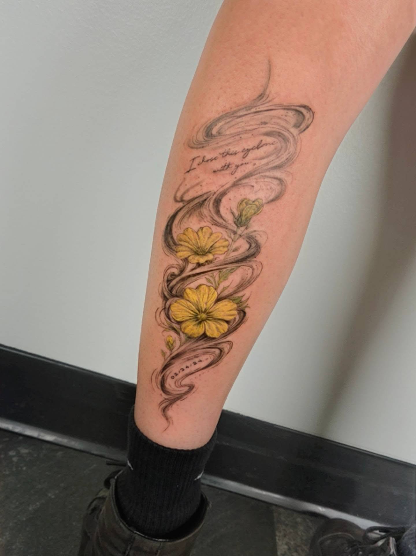 Yellow flowers and swirling lines black and grey tattoo on the forearm by ๐๐ฎ๐ป๐ฎ๐ถ๐, Charlotte, North Carolina