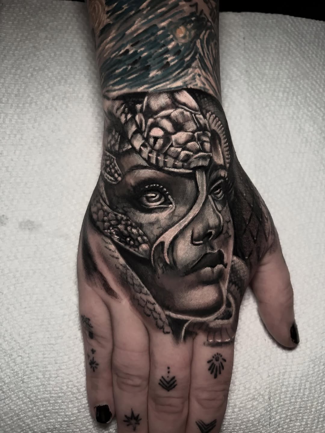 Medusa with snake realism tattoo on the hand by Ashley Denise