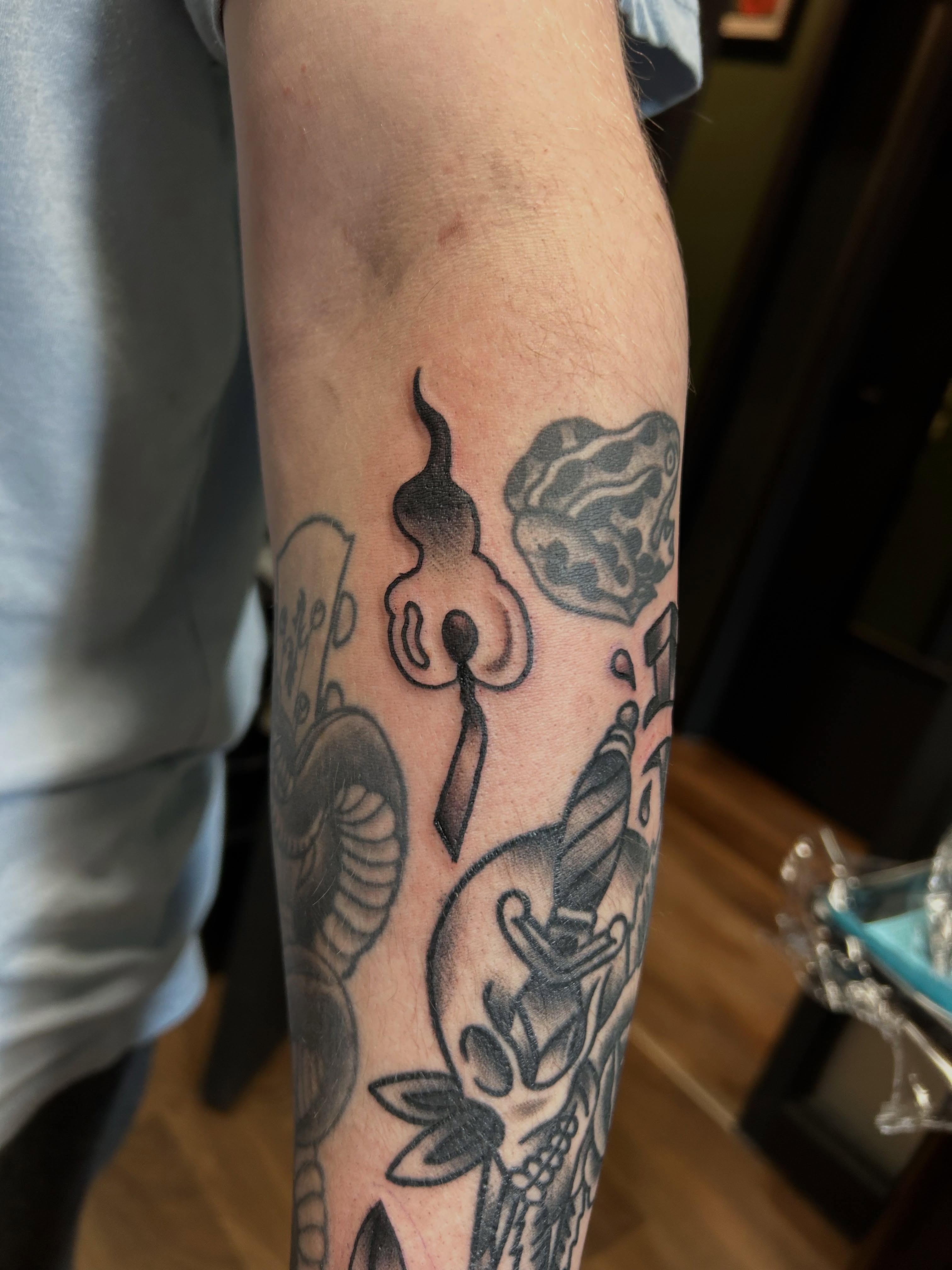 Mask and snake black and grey tattoo on the forearm by ⚡️𝑺𝑻𝑬𝑽𝑬 𝑩𝑼𝒀𝑨𝑪𝑯𝑬𝑲⚡️