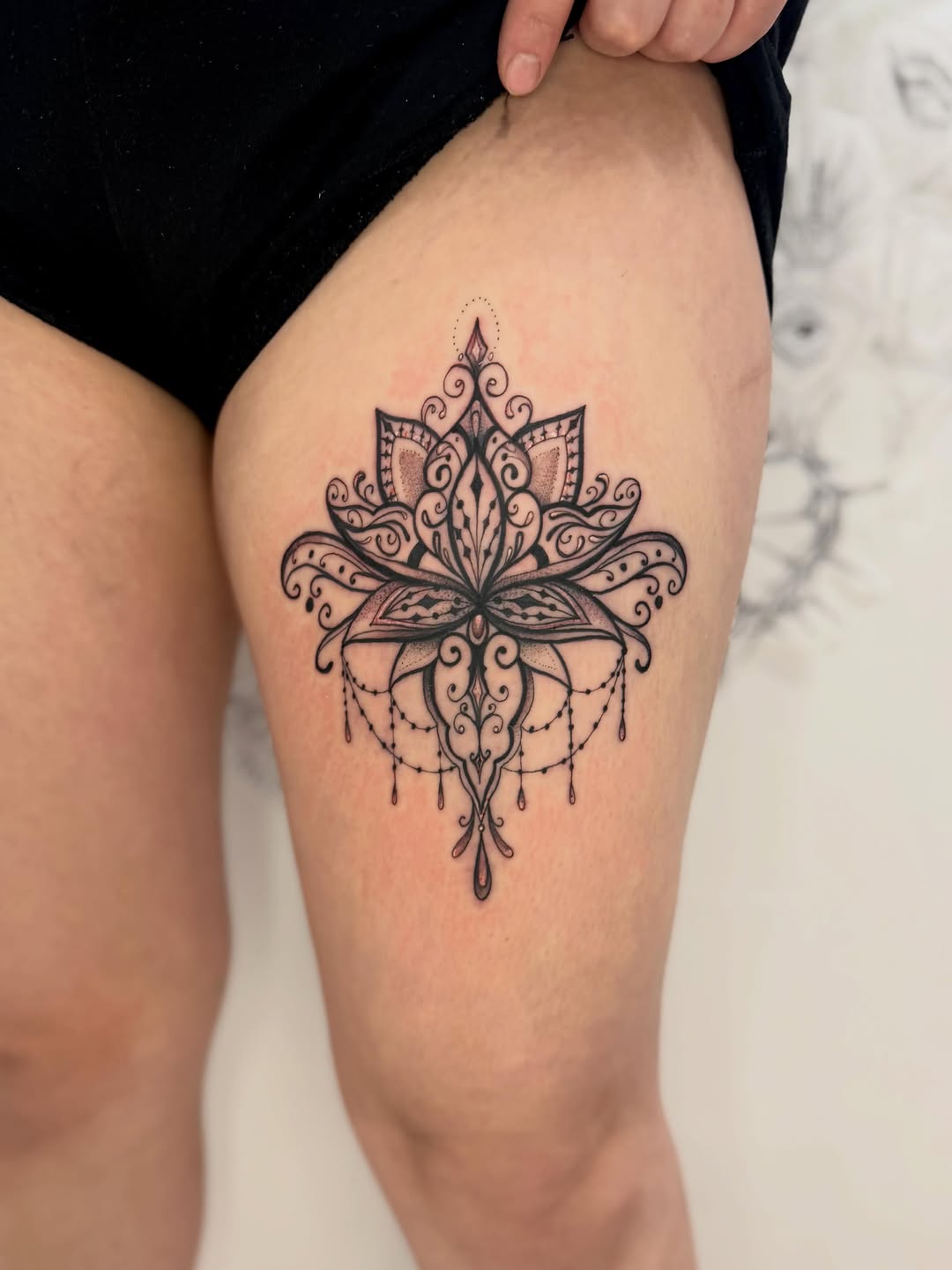 Lotus mandala ornamental tattoo on the thigh by Sasha “Sashimi” Shabasov