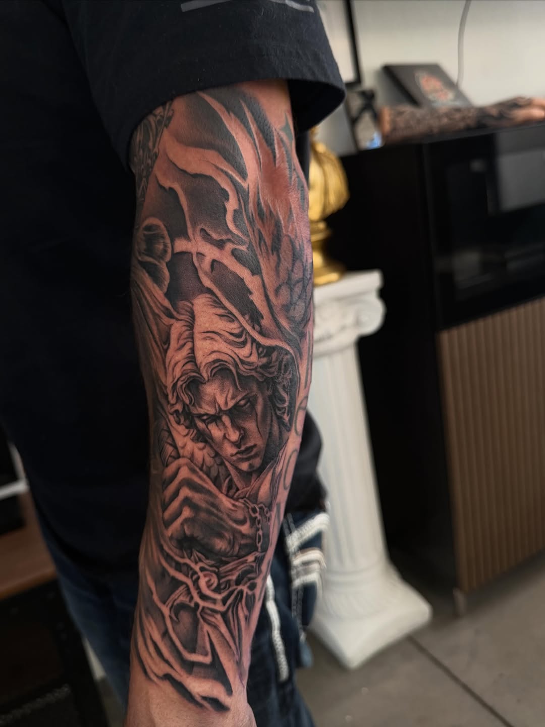 Fallen angel with chains realism tattoo on the forearm by Las Vegas tattoo Artist