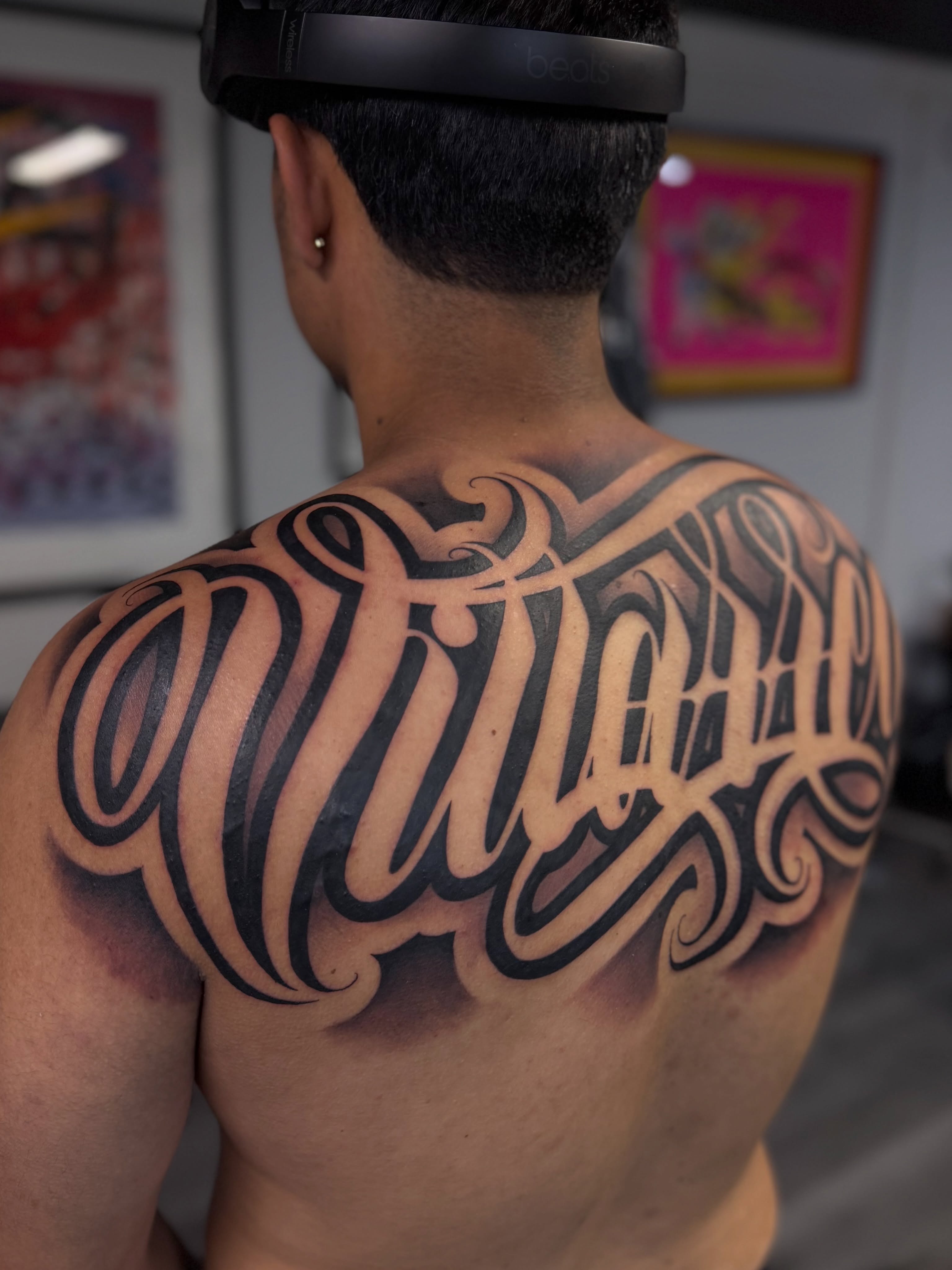 Script lettering lettering script tattoo on the back by Rocky G Inkz LLC