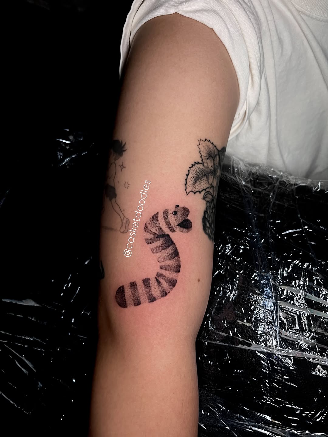 Cartoon worm ignorant tattoo on the forearm by clarissa