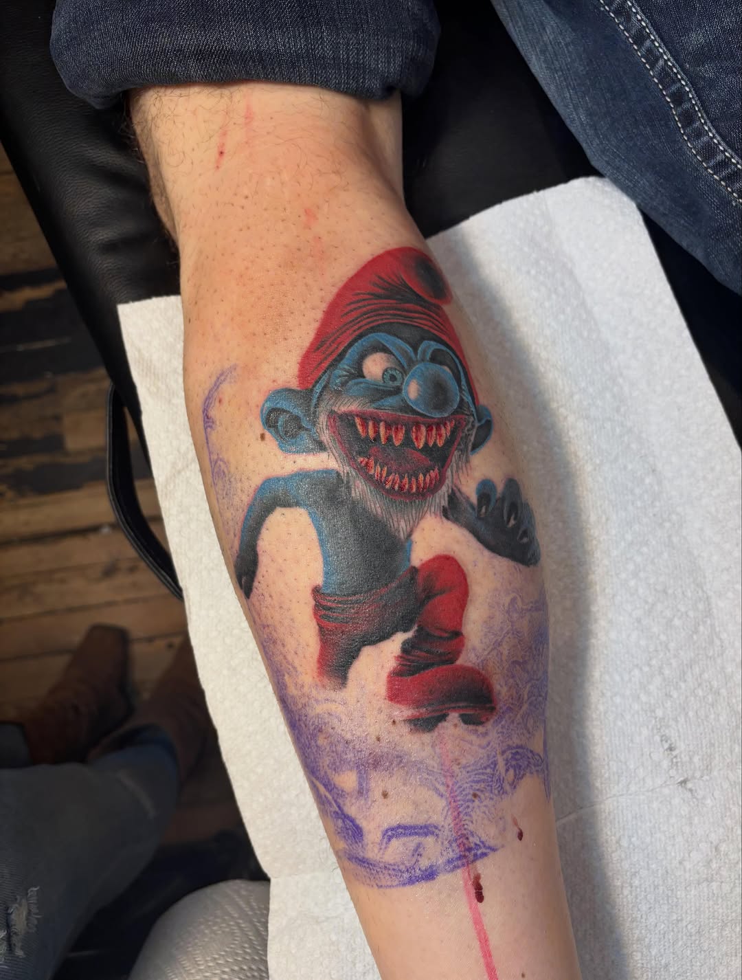 Evil smurf new school tattoo on the forearm by Aubri Aunna