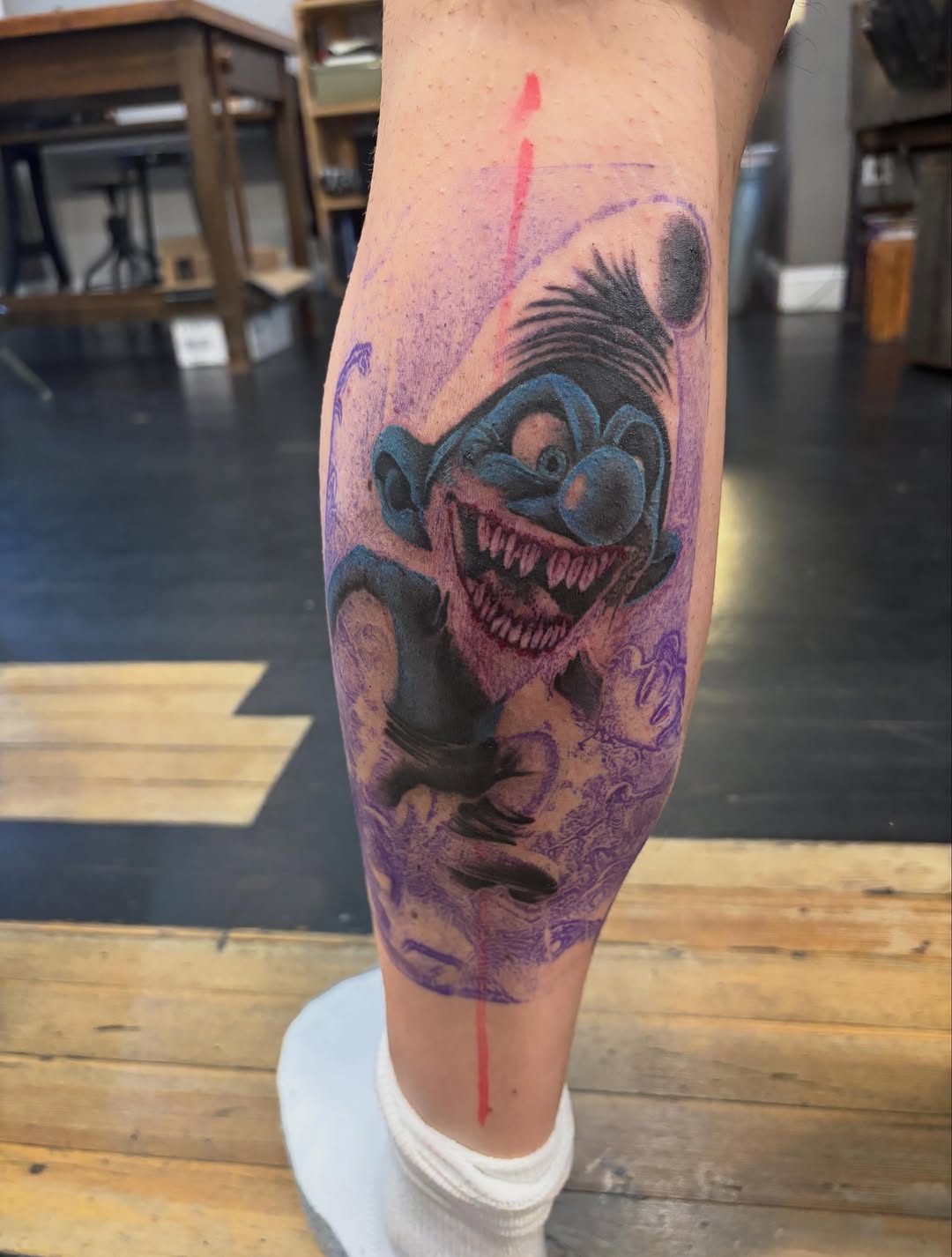 Creepy clown character realism tattoo on the forearm by Aubri Aunna