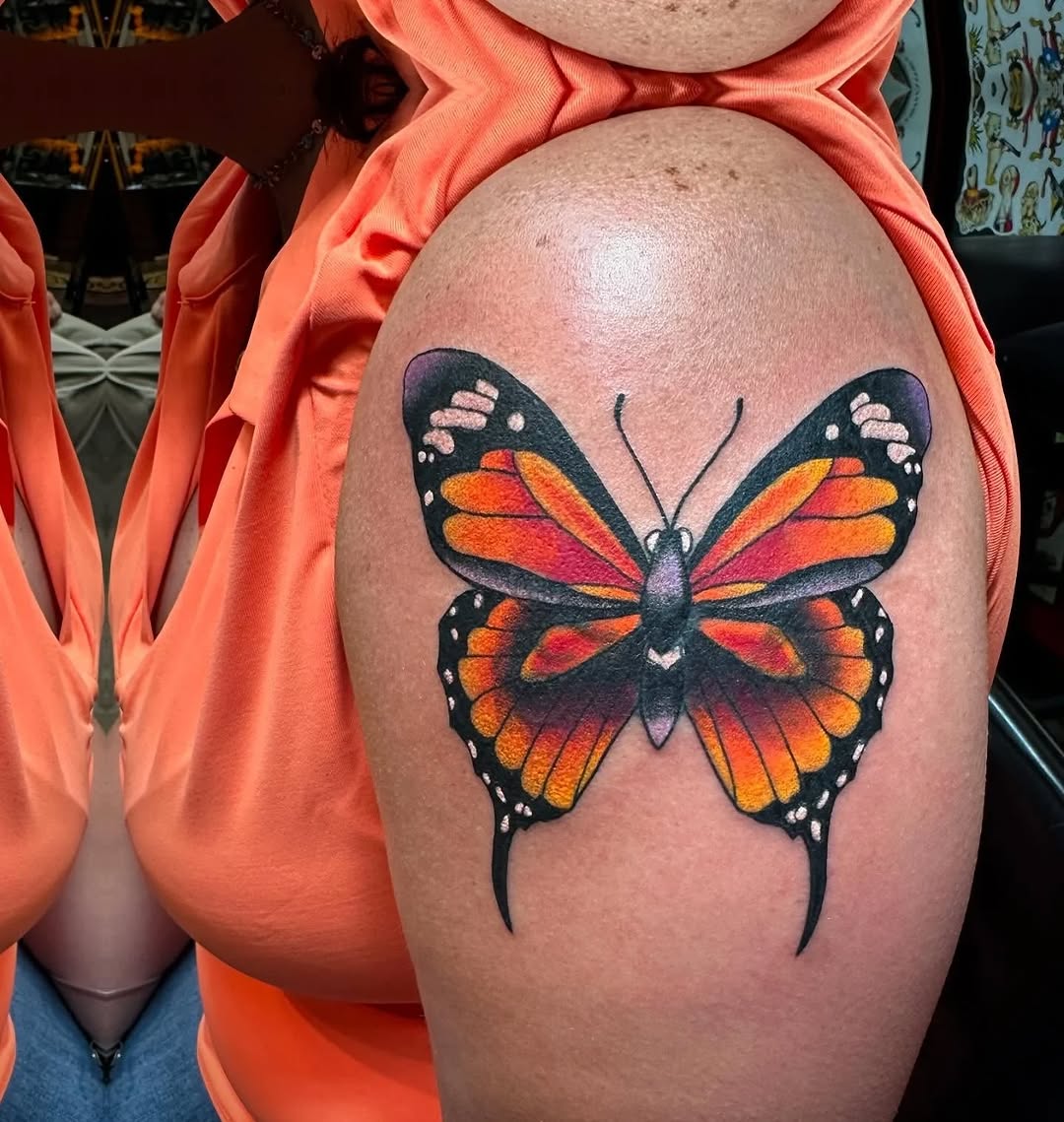 Monarch butterfly watercolor tattoo on the shoulder by Greyson Heidenreich