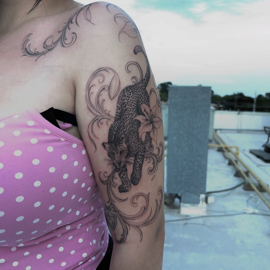 Leopard and lily with ornamental swirls realism tattoo on the shoulder by syiko ☆ 。・:*˚:✧。, Austin, Texas