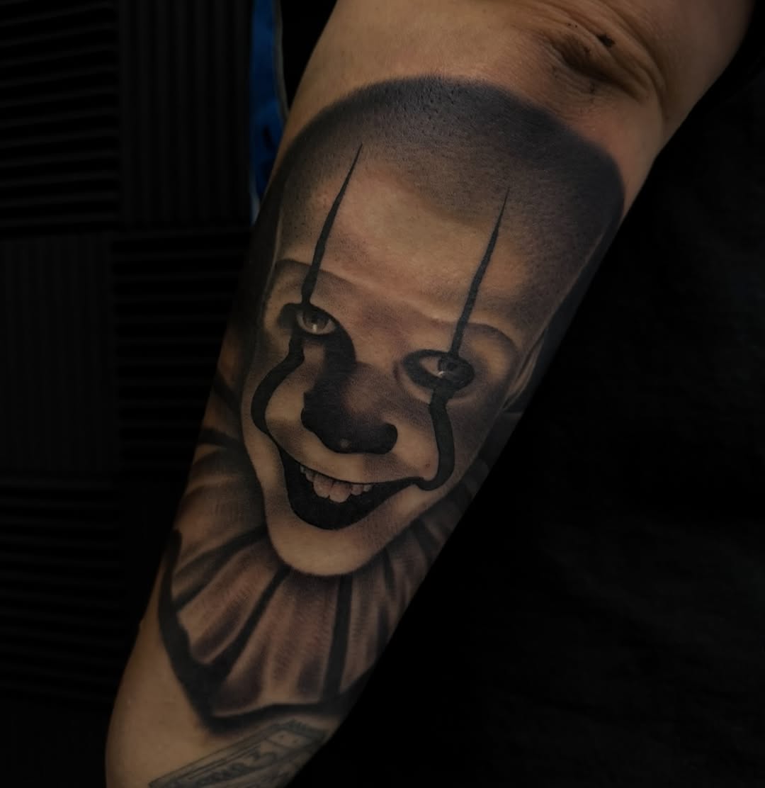 Pennywise the clown portrait realism tattoo on the forearm by Nick Campbell