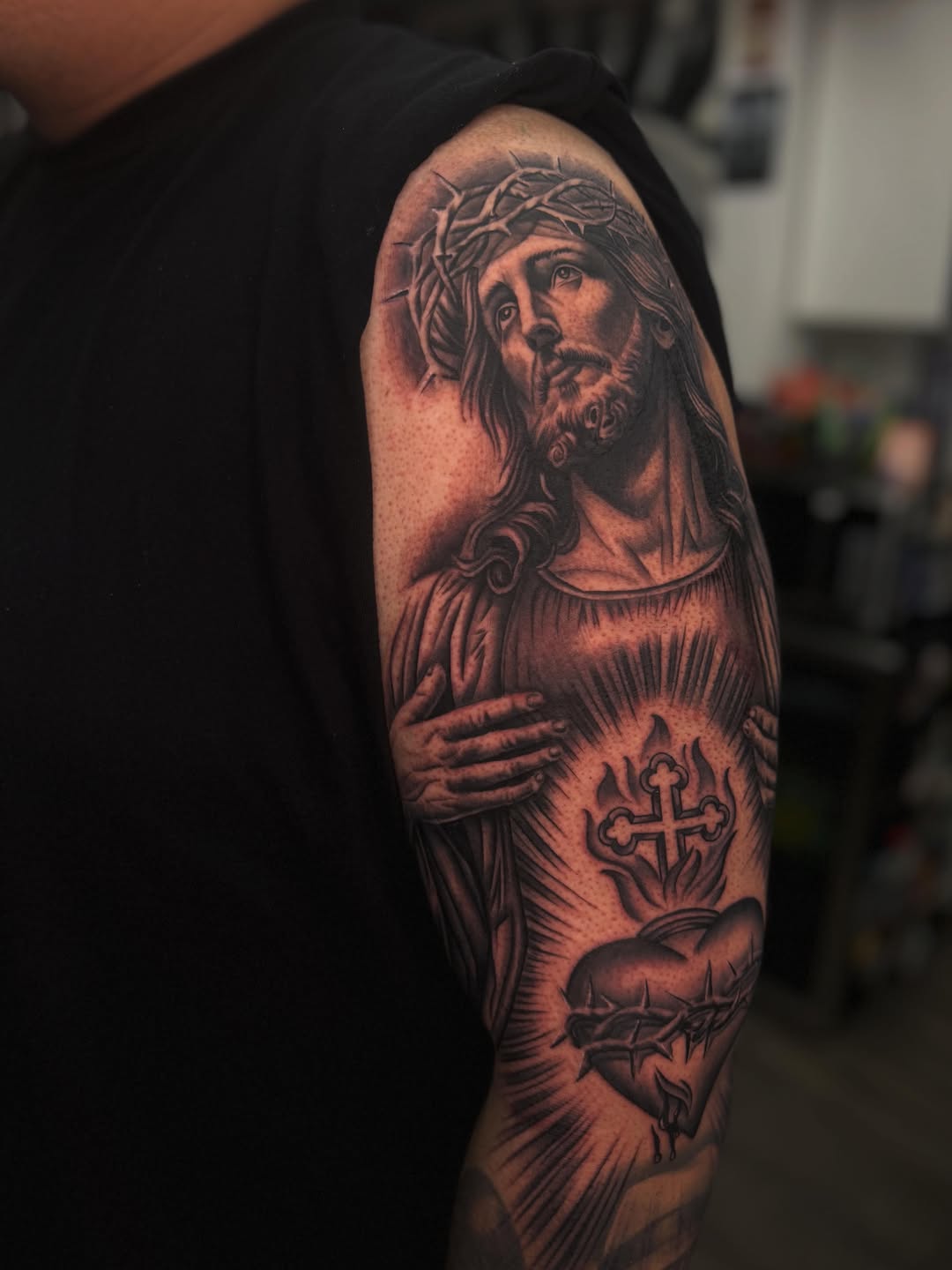 Jesus Christ and Sacred Heart realism tattoo on the upper arm by LOS