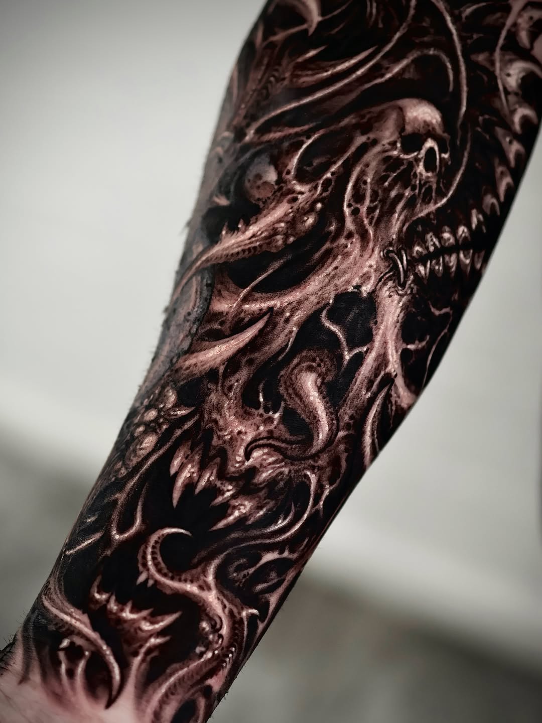 Demonic skull and tendrils realism tattoo on the forearm by Dark tattoo