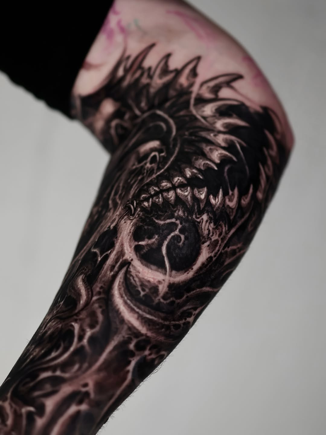 Demonic creature face realism tattoo on the forearm by Dark tattoo