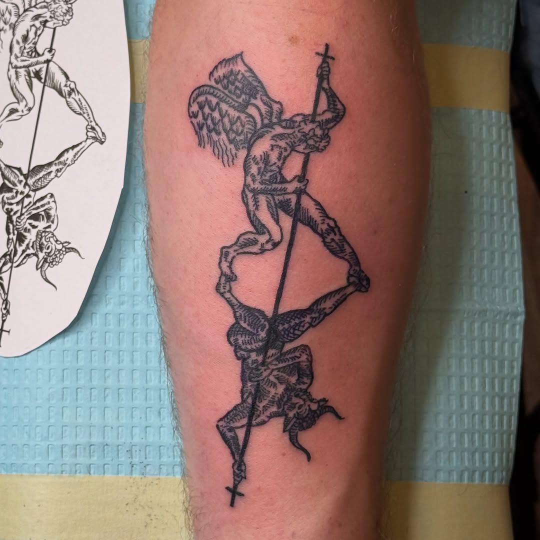 Angel and demon fighting realism tattoo on the forearm by Eric Guntor, Philadelphia, Pennsylvania
