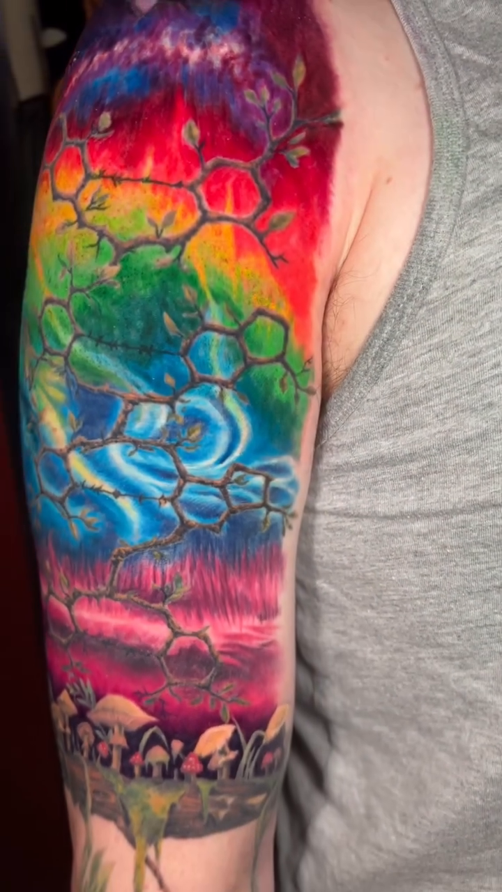 Watercolor tattoo on the upper arm by Paisley Diaz, Lombard, Illinois