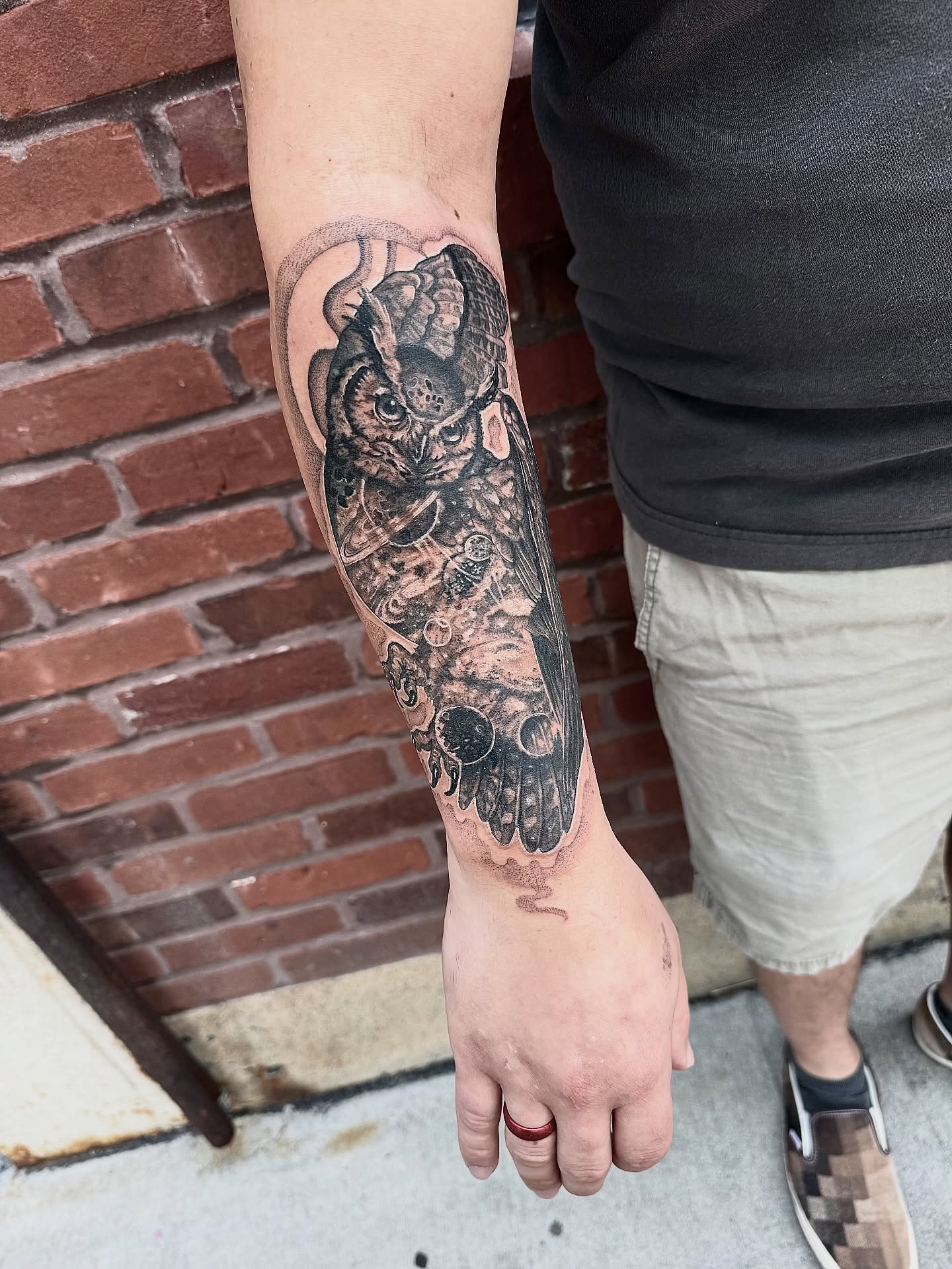 Owl black and grey tattoo on the forearm by Danielle