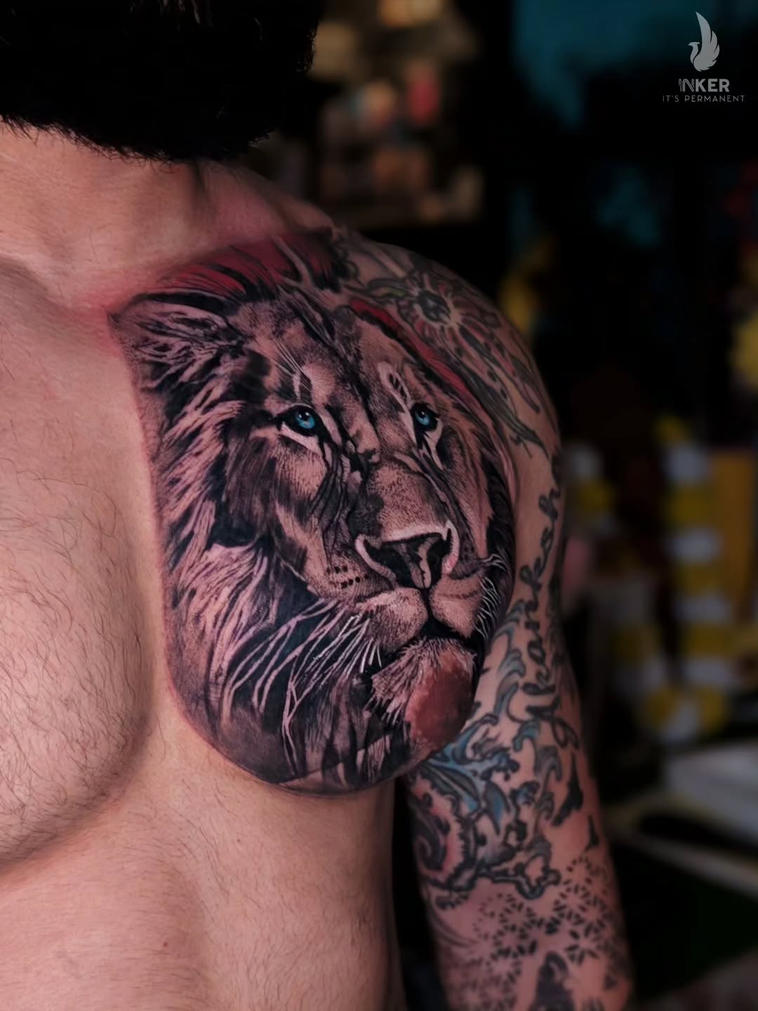 Lion portrait realism tattoo on the shoulder by Shubhadeep Mukherjee