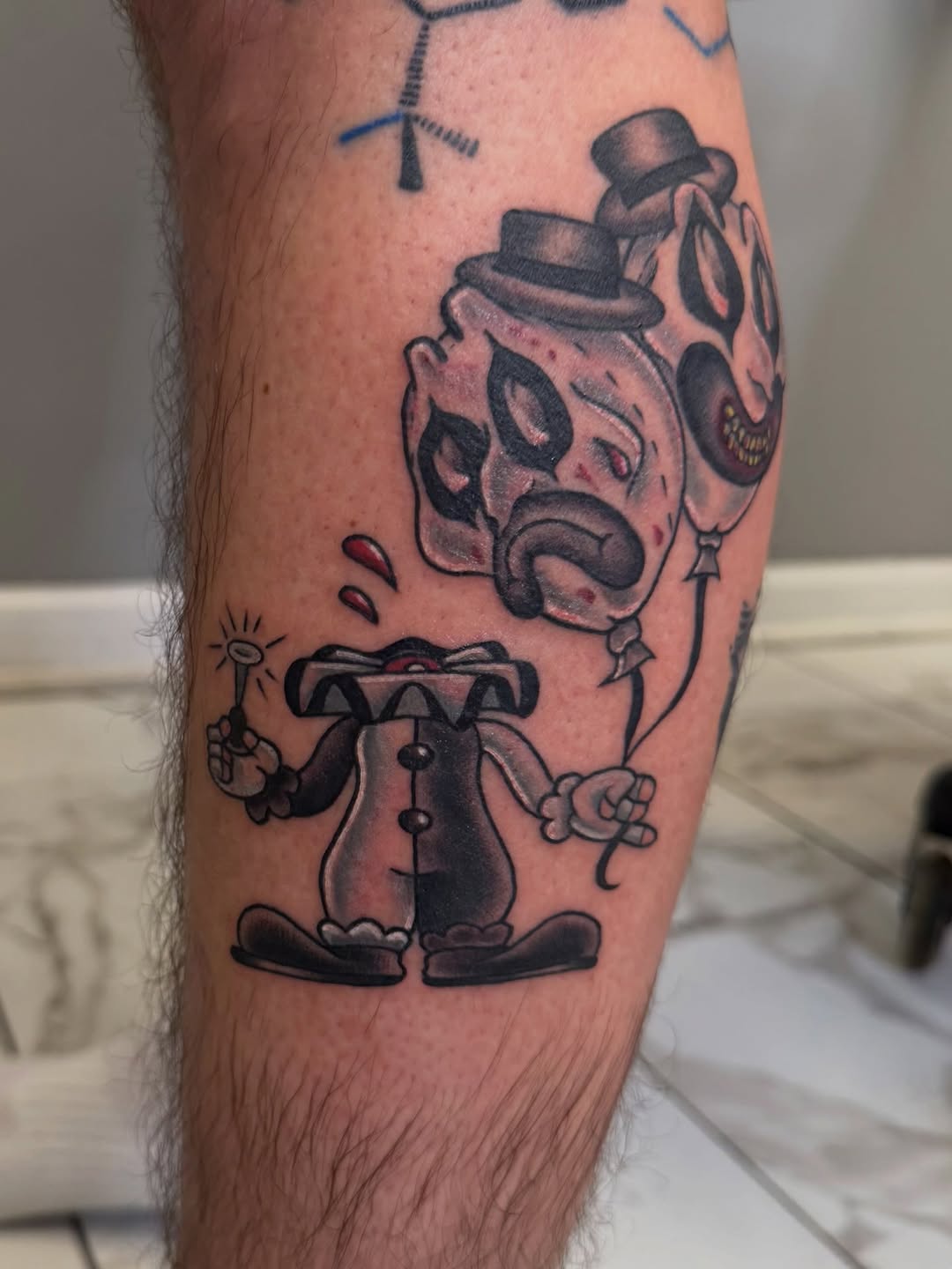 Headless clown with balloons realism tattoo on the forearm by linda perez