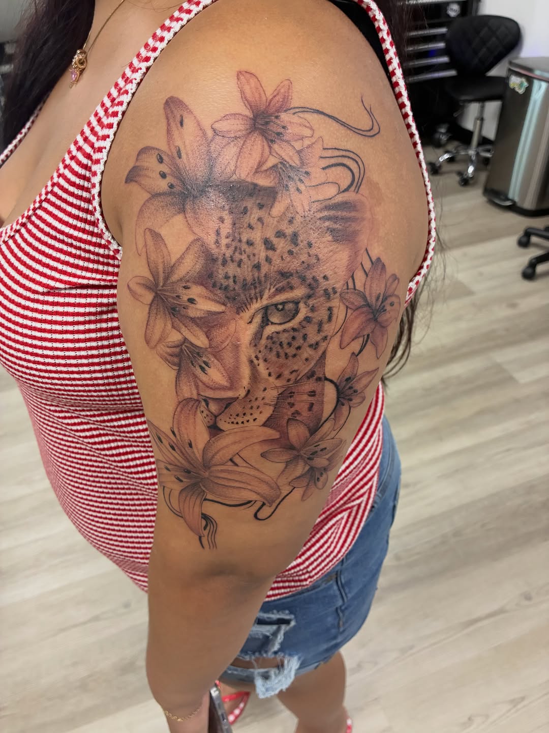 Leopard and lilies realism tattoo on the shoulder by Tattzbyluma, Charlotte, North Carolina