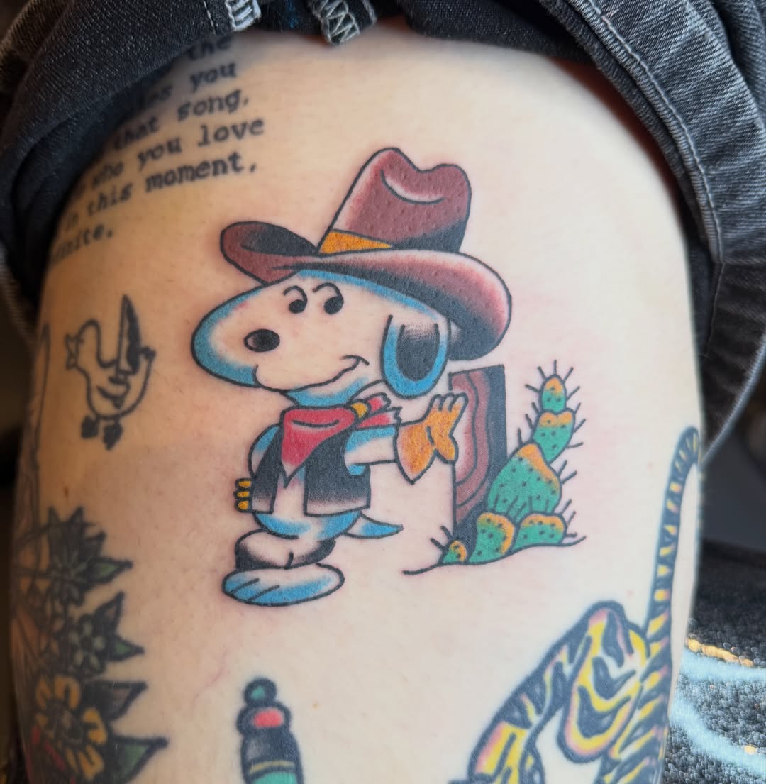 Cowboy snoopy American traditional tattoo on the thigh by Carl Testi