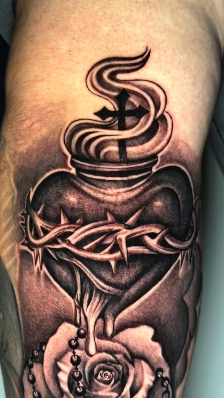 Sacred Heart with rose and rosary realism tattoo by professional tattoo artist