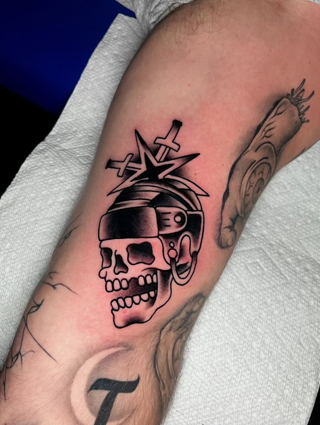 Skull with hockey helmet and swords realism tattoo on the forearm by Nick Andrade Las Vegas Tattoo Artist