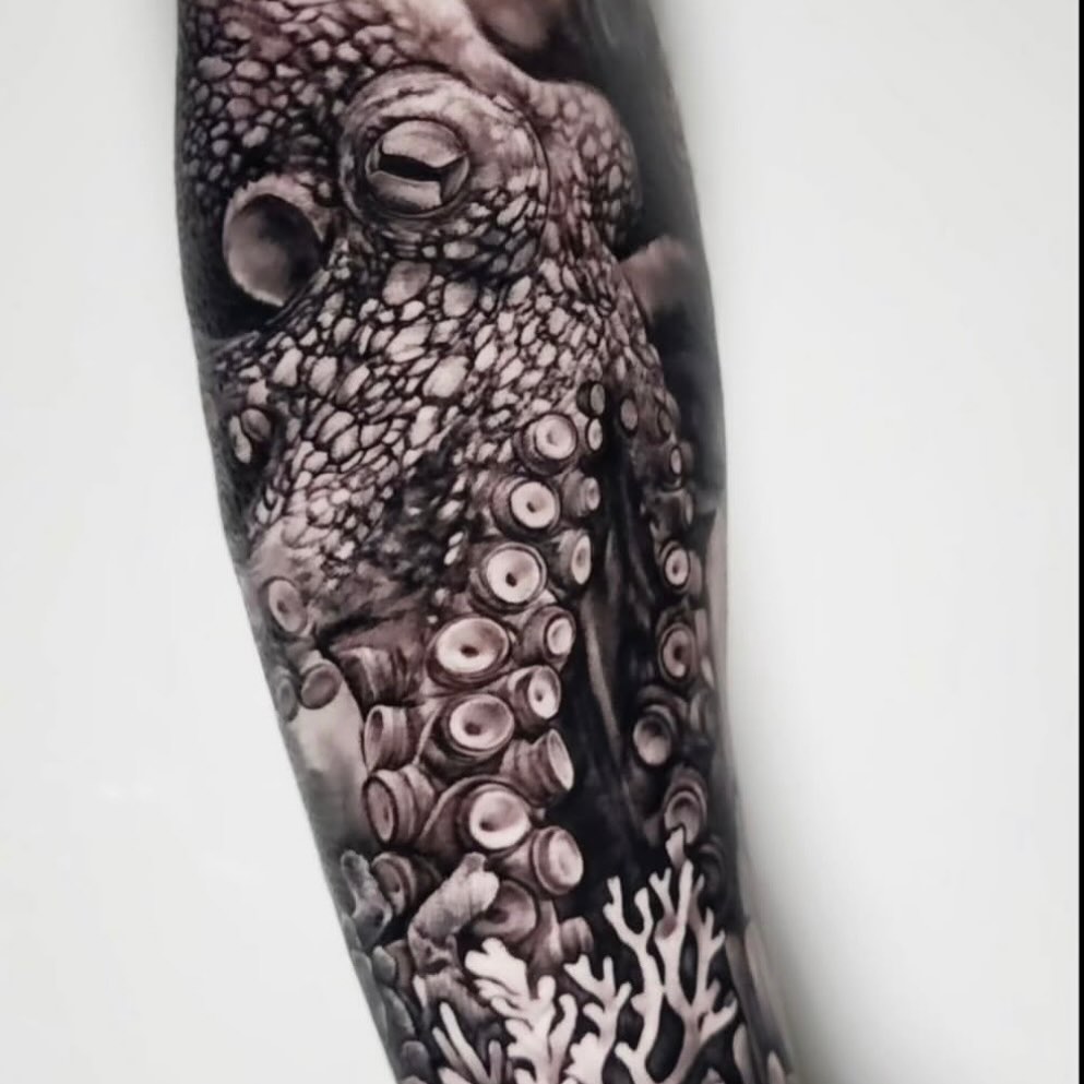 Octopus and coral surrealism tattoo on the forearm by Elidia Veliz