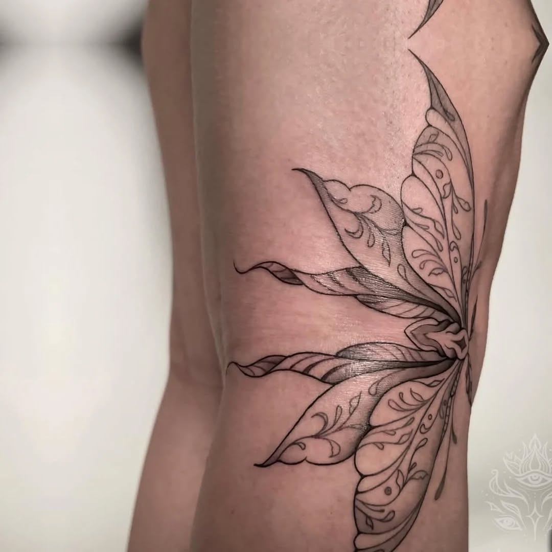 Ornate butterfly wings fine line tattoo on the forearm by Mazie O'Kon