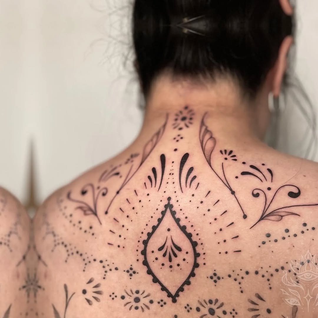 Ornamental pattern with dots and flourishes ornamental tattoo on the back by Mazie O'Kon