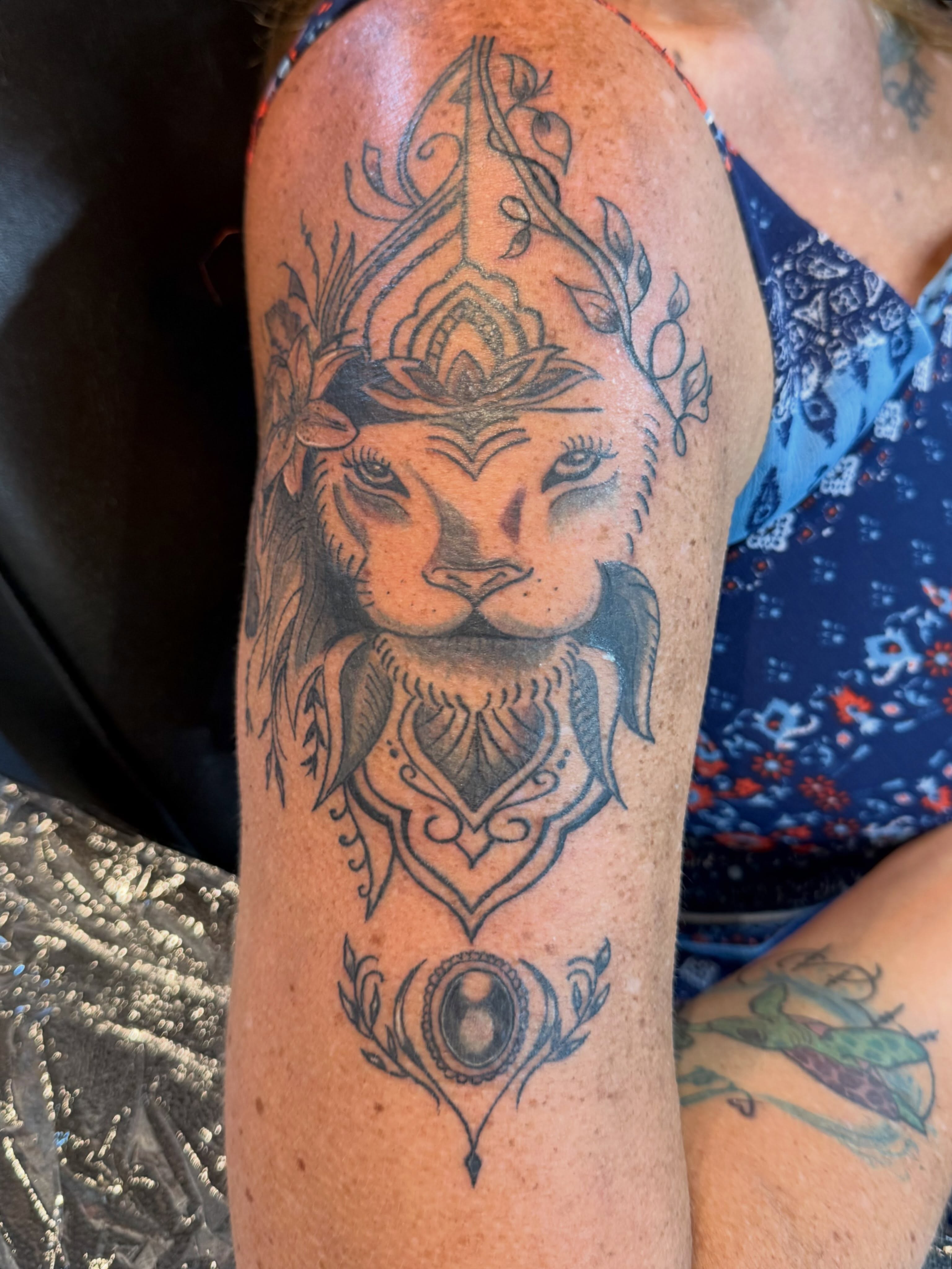 Lion geometric tattoo on the forearm by Darby Antonucci