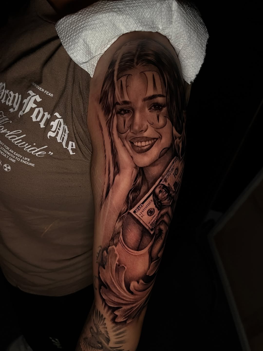 Woman with money Chicano tattoo on the forearm by Denver Tattoo Artist