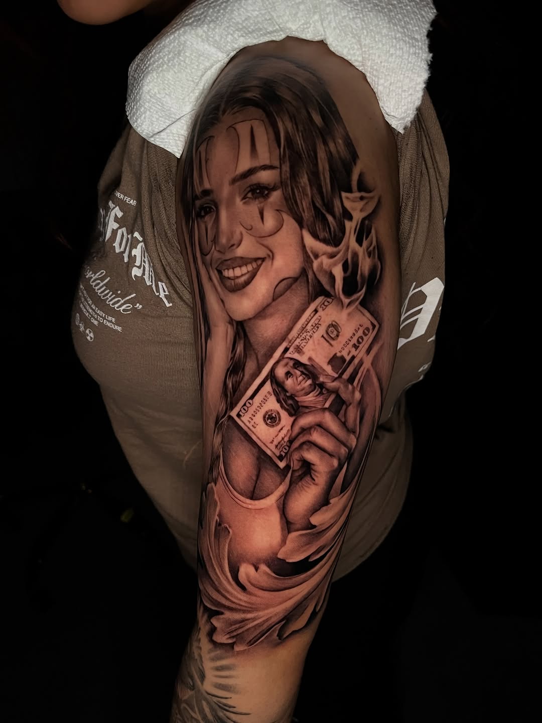 Woman holding money Chicano tattoo on the forearm by Denver Tattoo Artist