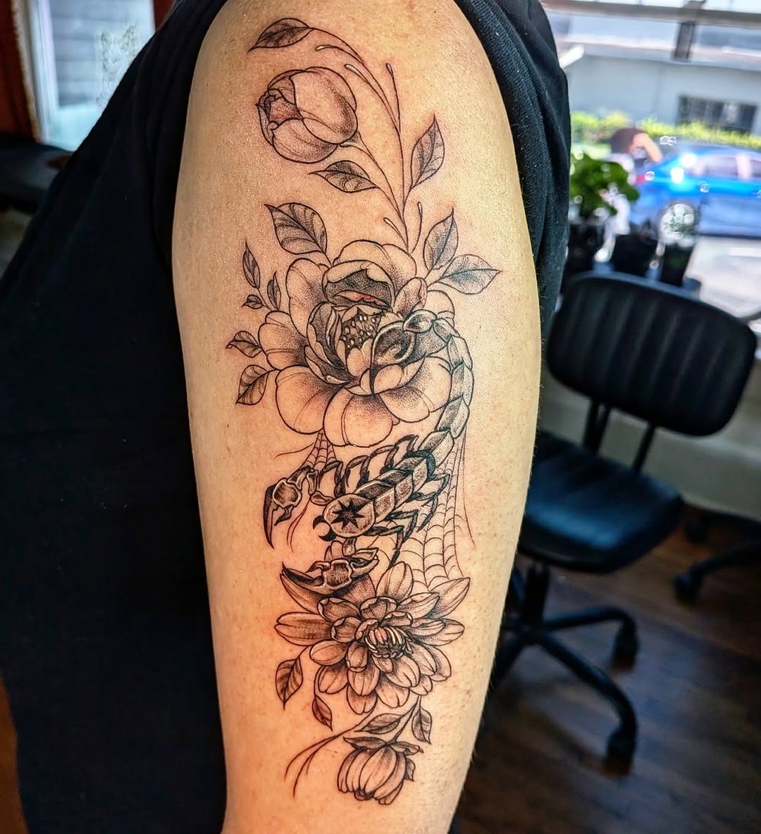 Scorpion and flowers fine line tattoo on the forearm by Shannon