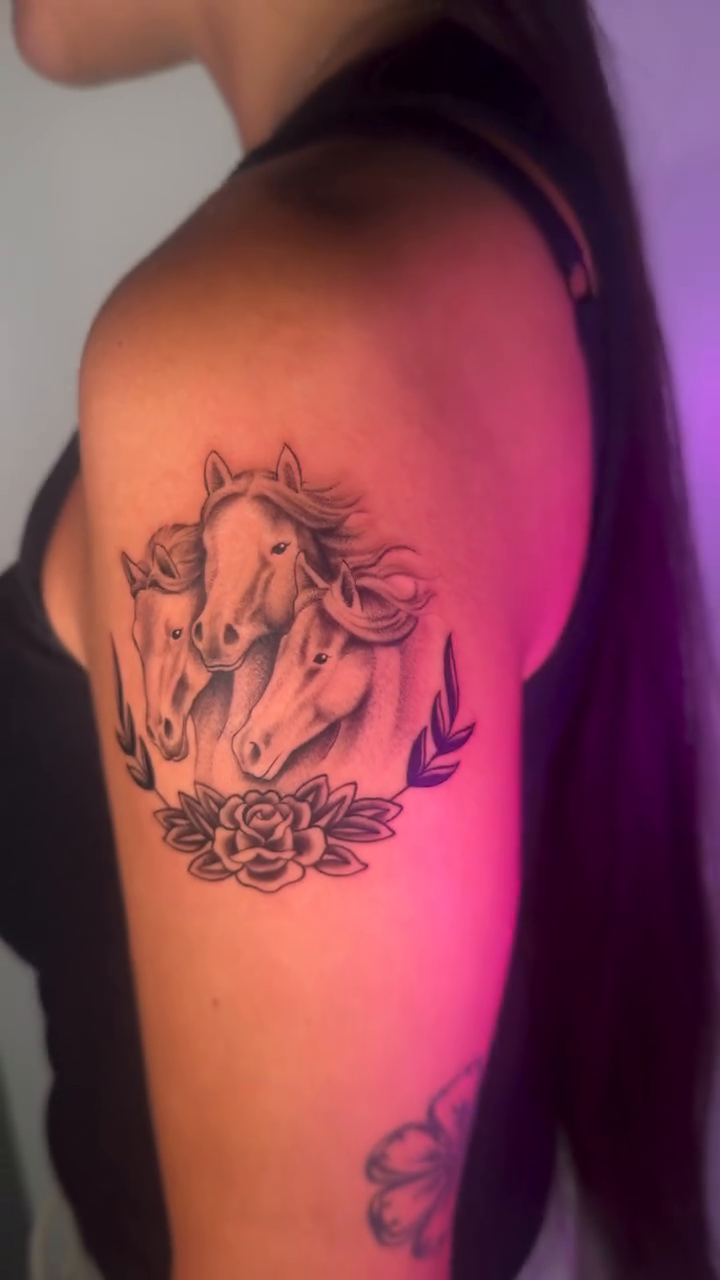 Three horses with roses realism tattoo on the shoulder by Monica Gonzalez