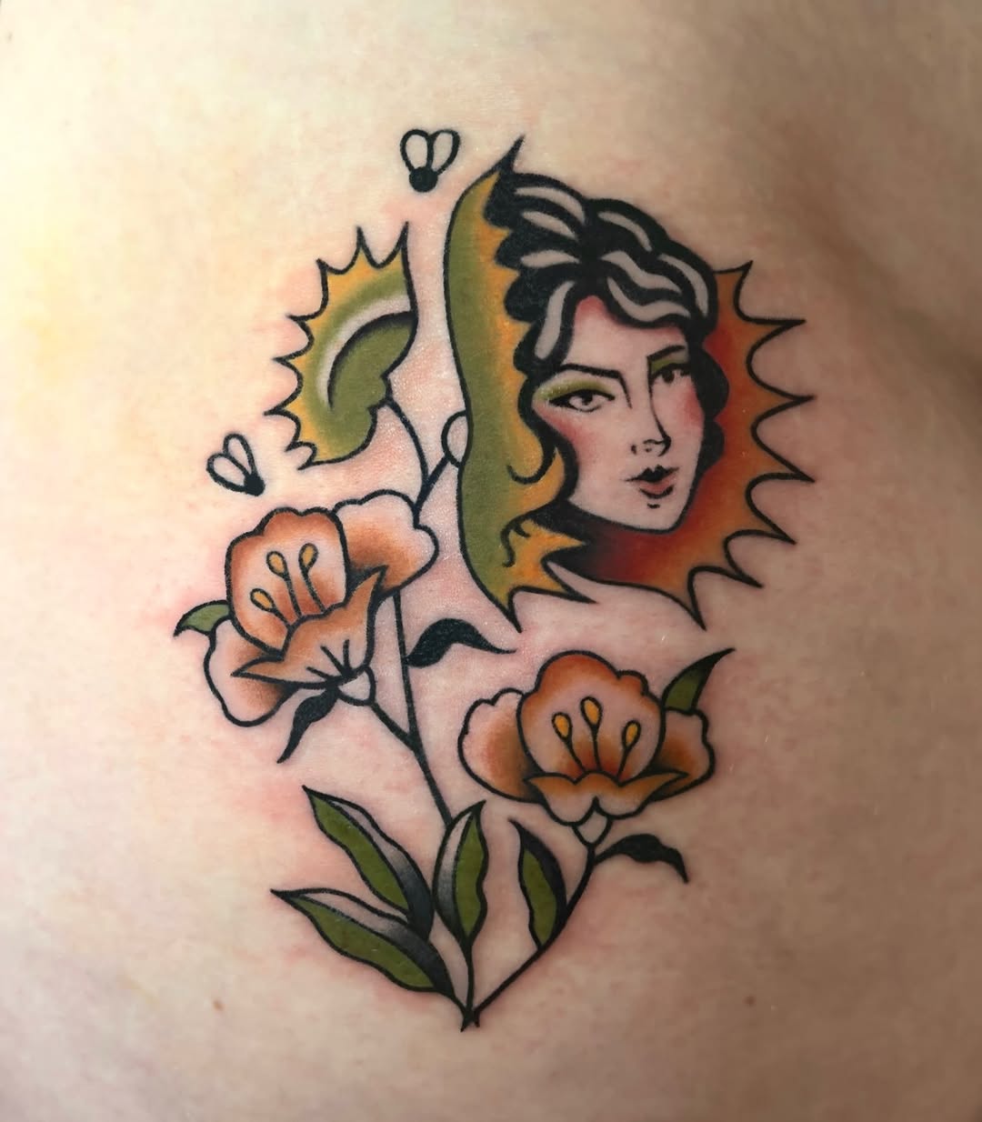Woman's face with flowers neo-traditional tattoo on the chest by M