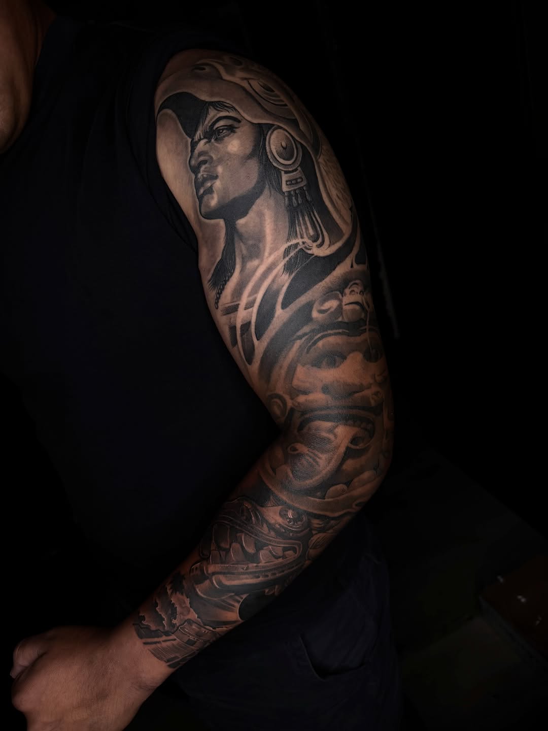 Aztec warrior portrait and mask surrealism tattoo on the upper arm by San Diego Tattoo Artist