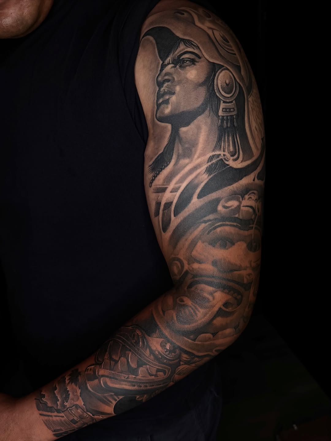 Aztec warrior portrait and imagery surrealism tattoo on the upper arm by San Diego Tattoo Artist