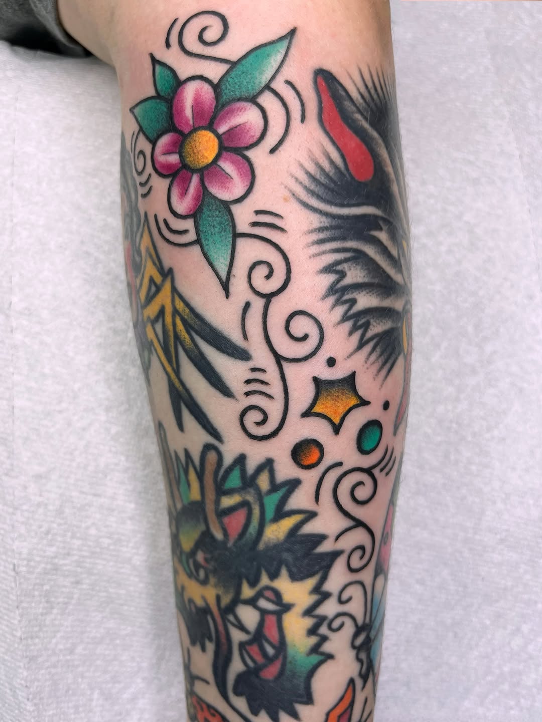 Flower and dragon American traditional tattoo on the forearm by Sara Atamian, San Diego, California