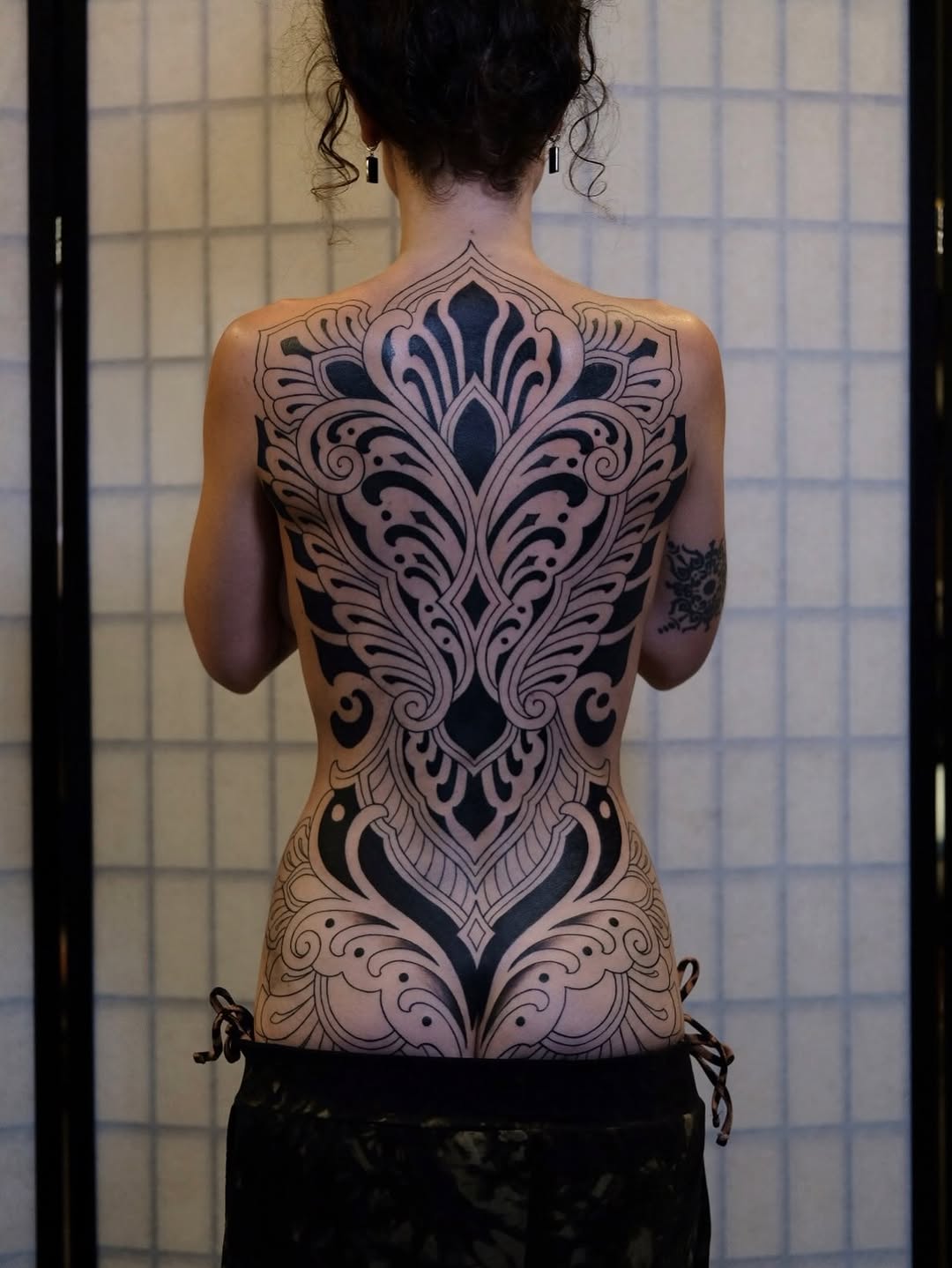 Ornamental full back piece tribal tattoo on the back by Owlyn Madrone