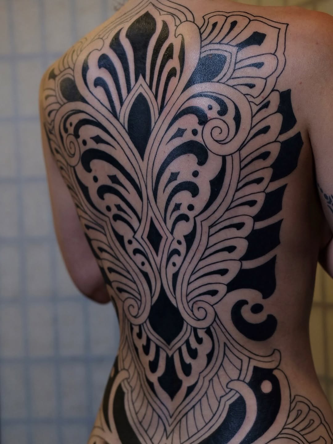 Ornamental back piece tribal tattoo on the back by Owlyn Madrone