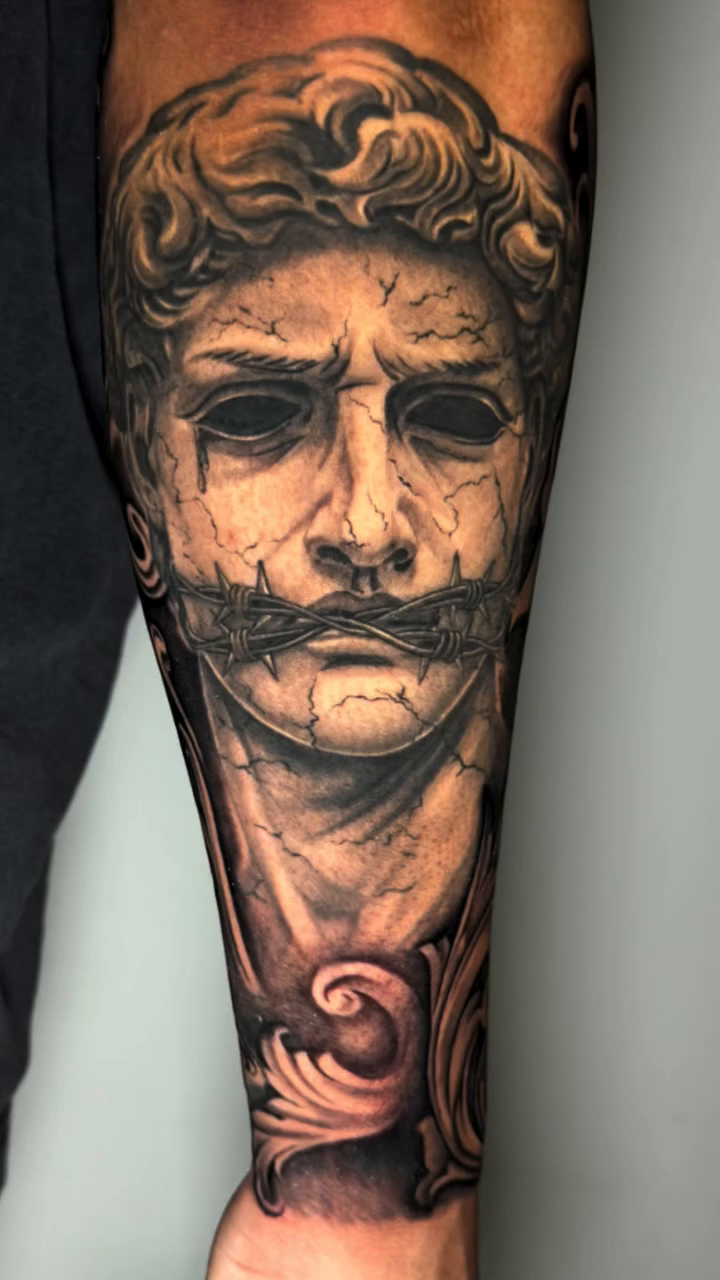 Bust of a man and filigree realism tattoo by professional tattoo artist