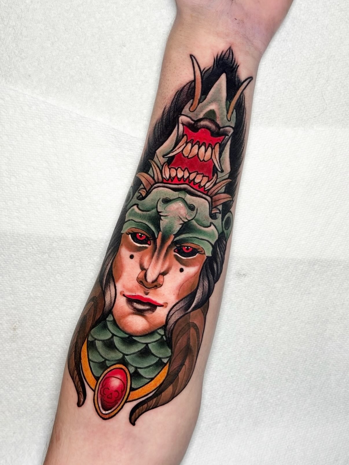Woman with dragon headdress American traditional tattoo on the forearm by 𝐀𝐧𝐝𝐲 𝐁𝐚𝐠𝐥𝐞𝐲