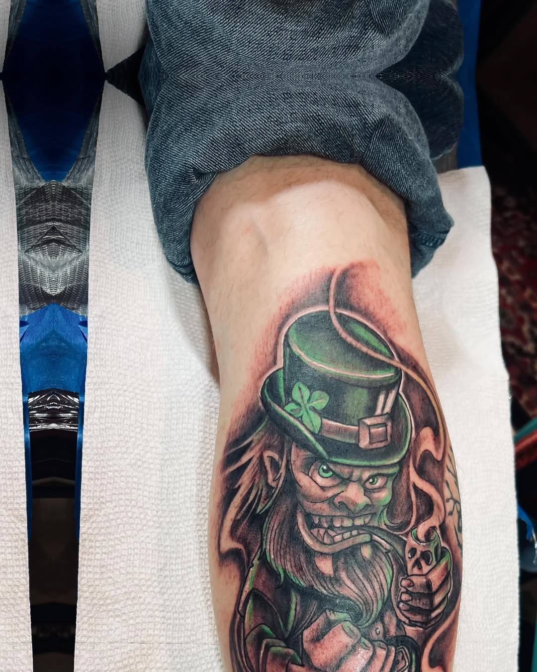 Leprechaun smoking pipe American traditional tattoo on the forearm by Watson Gutkowski