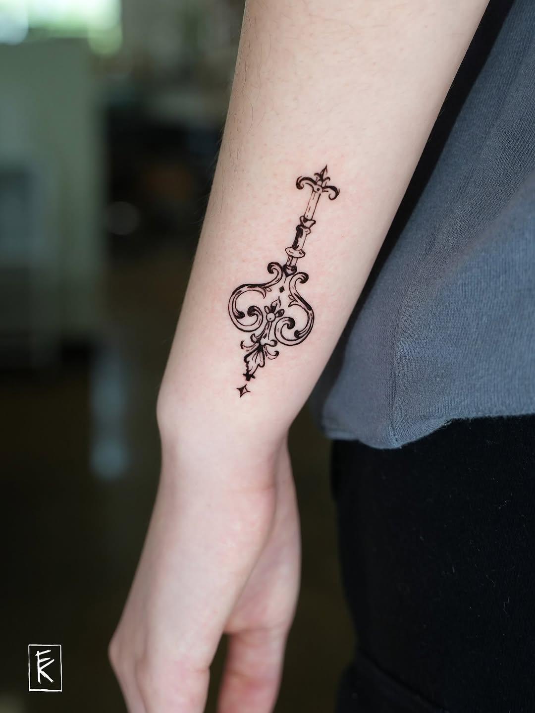 Ornate key ornamental tattoo on the forearm by elizaveta