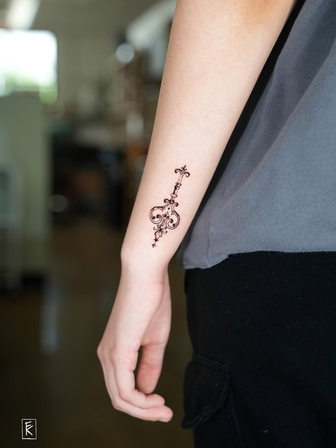 Ornamental key ornamental tattoo on the forearm by elizaveta